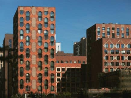 About Us 3 Modern urban buildings with unique architectural designs against a clear blue sky, highlighting the need for reliable locksmith services for enhanced security and access management.